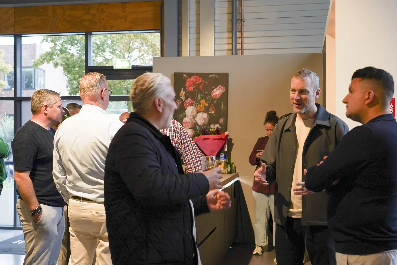 Kitchen4All-ondernemers in geanimeerd gesprek met een drankje tijdens de franchisevergadering