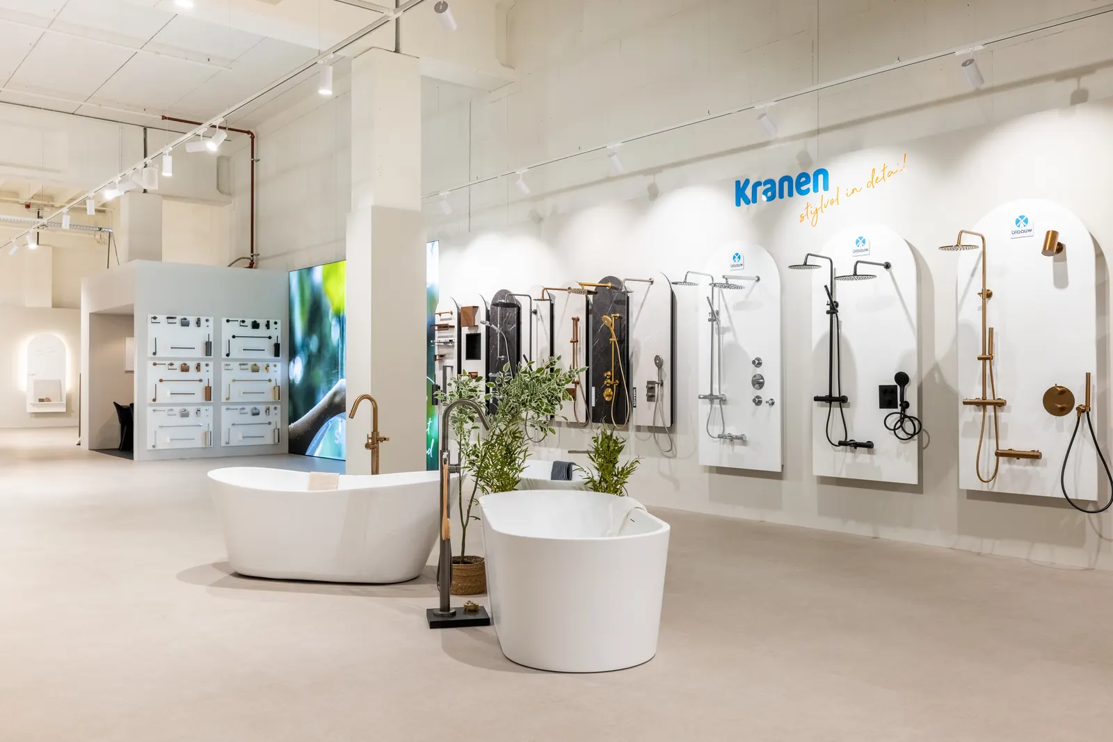 Kranenwand met vrijstaande baden in de lichte Sani4All-showroom in Apeldoorn